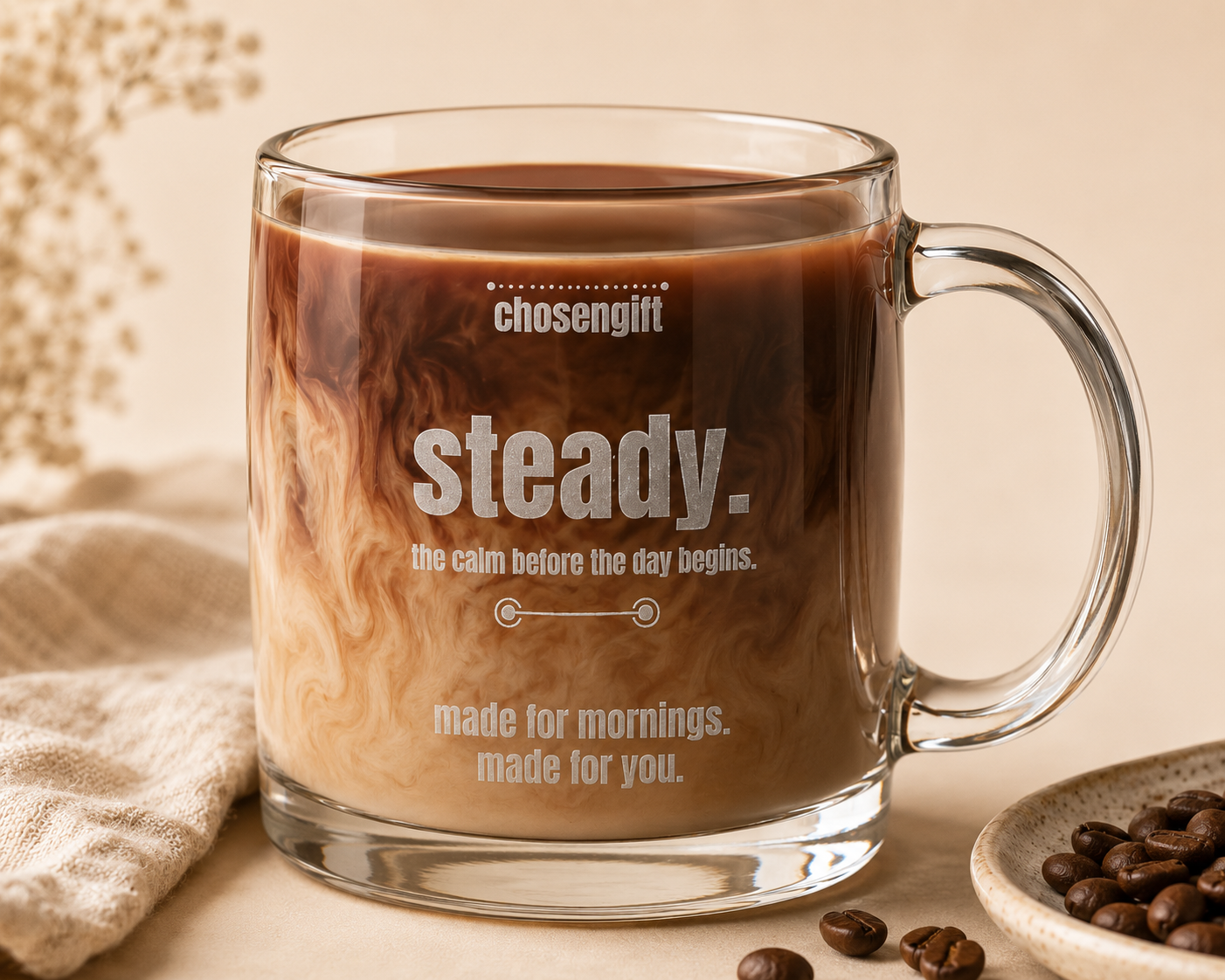 Close-up of clear glass coffee mug with permanent engraved morning message