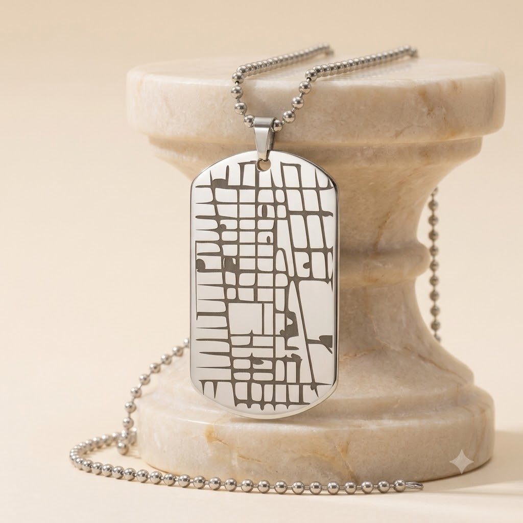 Back side of personalized map dog tag necklace with custom engraved text.