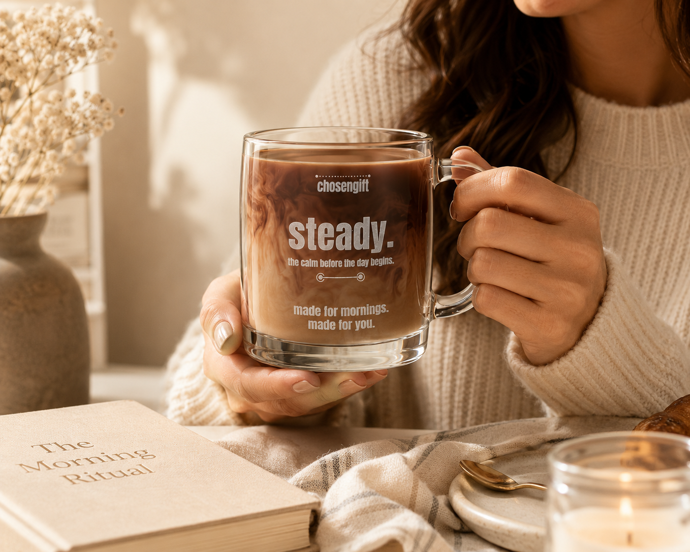 Woman holding a personalized engraved glass coffee mug during her morning routine